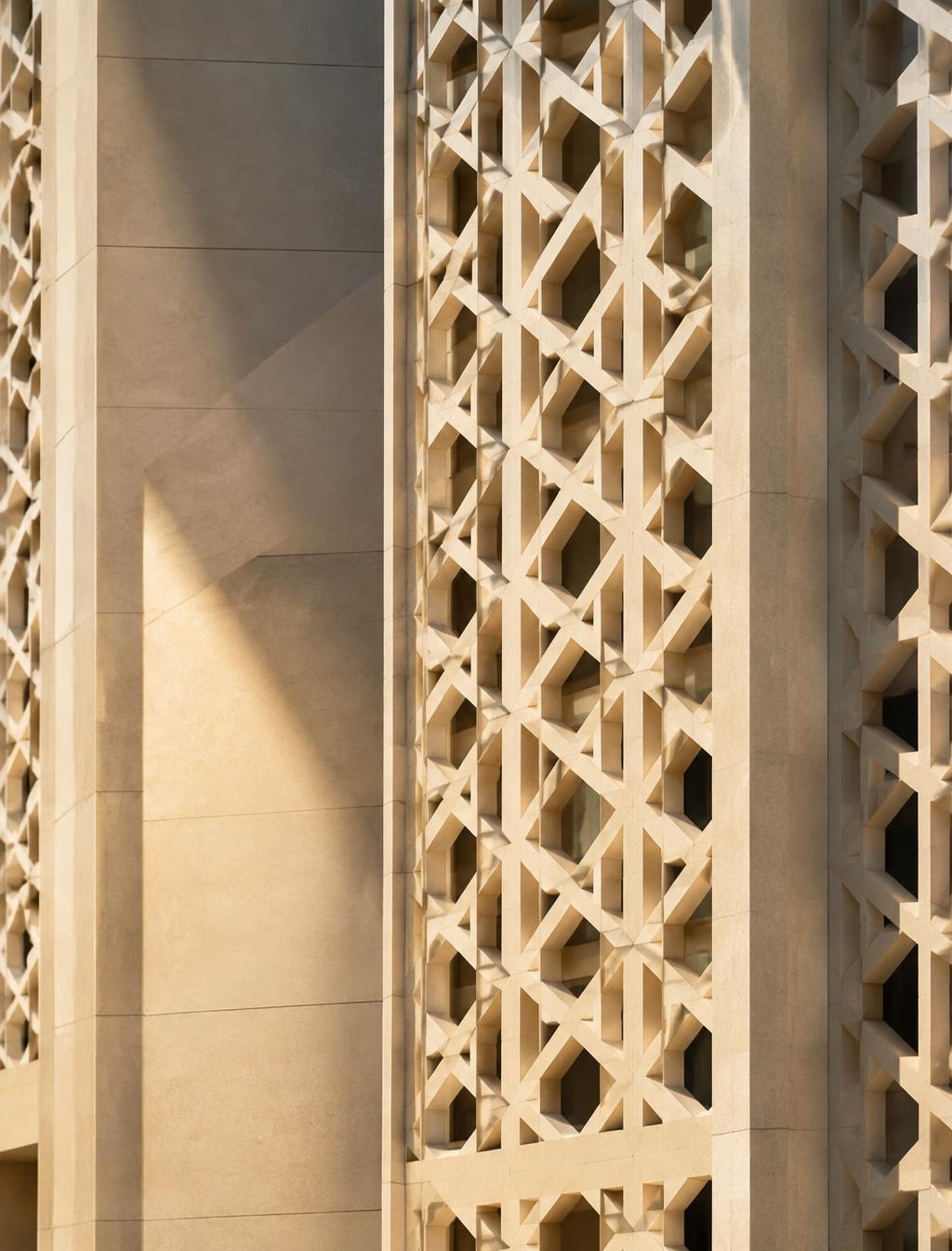 Geometric stone facade in warm light